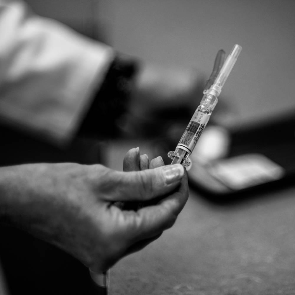 A close up of someone holding a vaccine